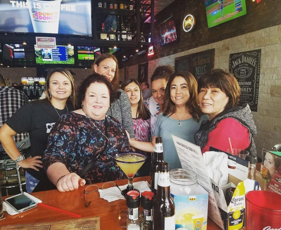 Image may contain: 9 people, including Sandy Lykins, people smiling, people sitting and indoor