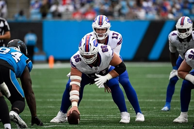 Connor McGovern, looking battle-worn, prepares to snap the ball on Josh Allen's command.