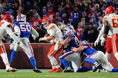 Greg Rousseau looks on as the conga line of Michael Hoecht and Christian Benford deliver one of the team's 3 sacks on Patty Mahomes.