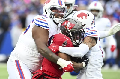 I don't know what's on DT Deone Walker's mind as he tackles Sean Tucker, but he certainly seems to be enjoying himself.