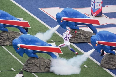 FB Reggie Gilliam fits right in with charging buffaloes as he takes the field.