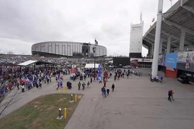 New meets old as fans head to the entrances of the old Highmark Stadium, with the new stadium beckoning in the distance.