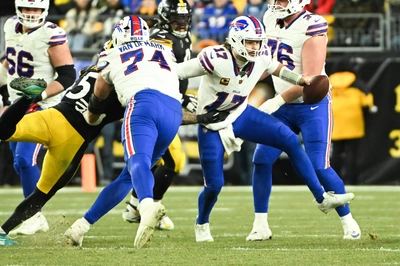 Ryan Van Demark shoves a defender away from Josh Allen as Allen begins one of his many successful scrambles for the game. The legs are back baby.