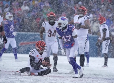 Christian Benford celebrates his first half sack of Cincy QB Joe Burrow(ed in the snow).
