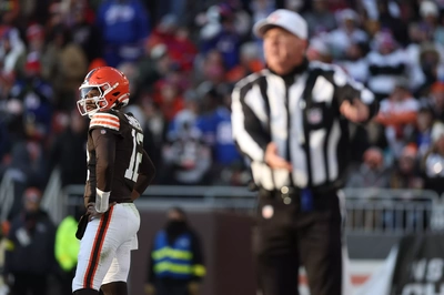 Gigantic, blurry Referee calls intentional grounding on Brown's QB Shedeur Sanders.