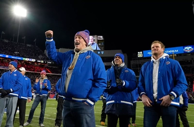 Bills legends Jim Kelly, Andre Reed and Eric Wood respond to the halftime video message from Marv Levy. Hidden behind Kelly is Thurman Thomas.