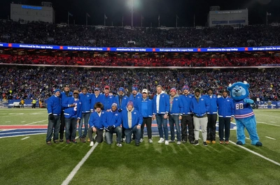 A proud group of former Bills assembled on the field for a halftime celebration that included a video message from centenarian, former HC, Marv Levy.
