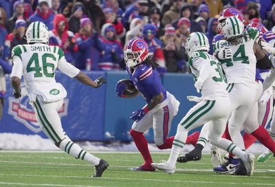James Cook carries the ball on the first play from scrimmage. Cook had two runs for 15 yards and finished the season as the NFL Rushing Champion with 1,621 yards to Derrick Henry's 1595.