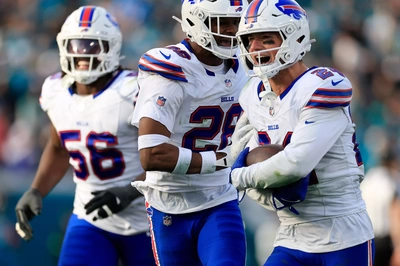 Sam Franklin Jr (28), and Javon Solomon (56) are the first to congratulate Cole Bishop after his interception that decided the Playoff game in the Bills favor.