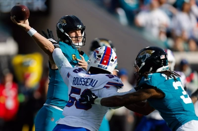 Trevor Lawrence winces as Greg Rousseau reaches him on a 4th period QB Pressure.