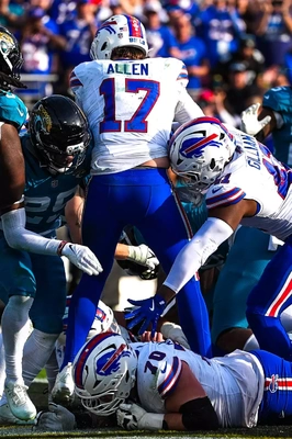 With his tush about to be pushed by Reggie Gilliam, Josh Allen heads to the end zone for the game winning touchdown in the Bills first road playoff win since they beat the Dolphins 29-10 in Miami on January 17, 1993, to advance to Super Bowl XXVII.