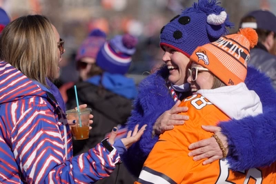 Bills fans Jaclyn Reale and Kelly Mahler show Bronco fans Tiffany Jordan what Zubaz is.