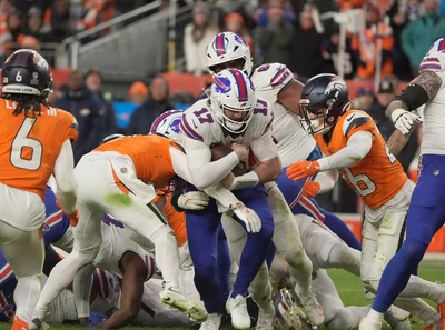 Josh Allen snow plows his way through the line on his way to a first down.